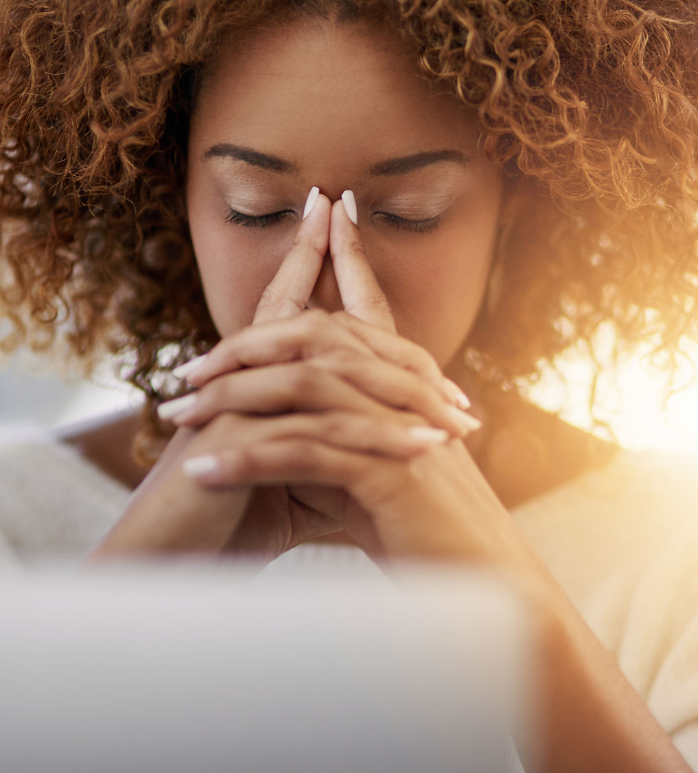 Frau mit geschlossenen Augen stützt Stirn auf die Hände – Symbolbild für psychischen Stress